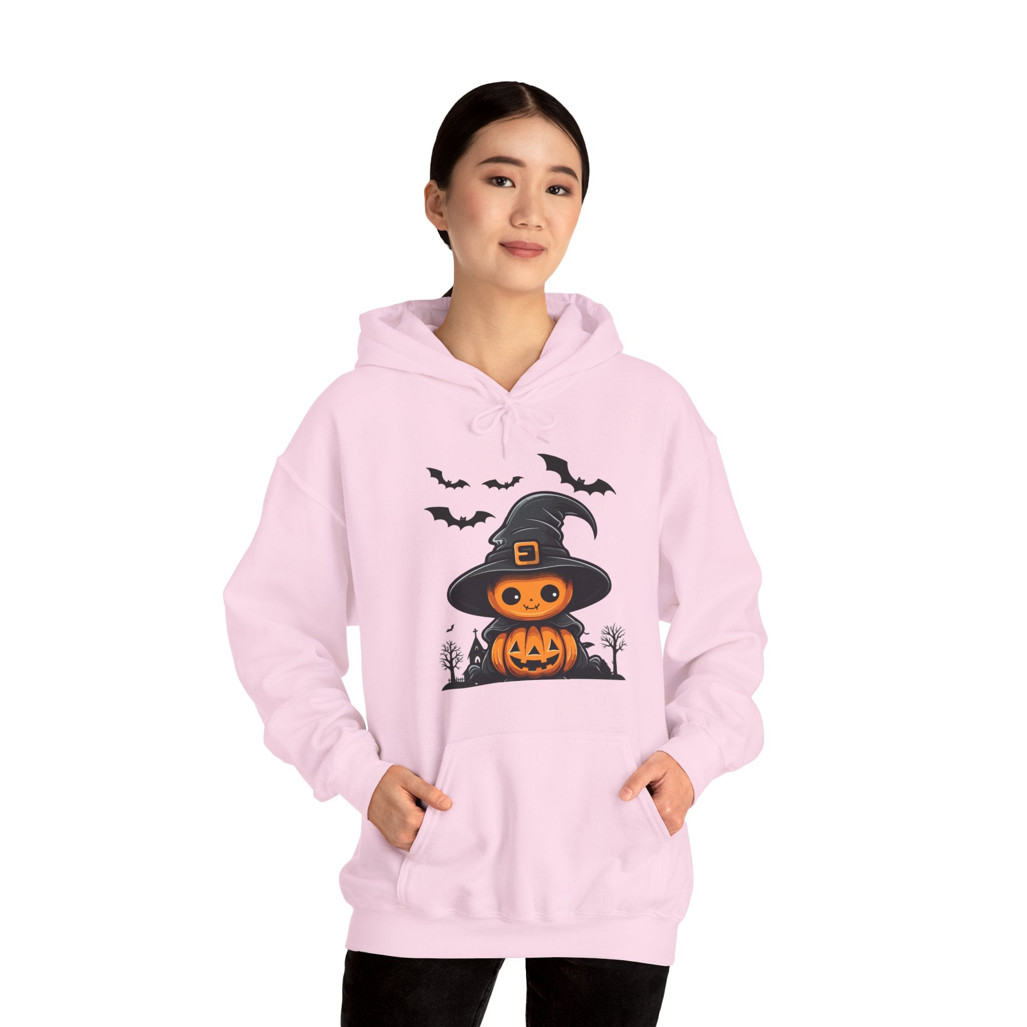 Person wearing a pink hoodie with Halloween design on a white background