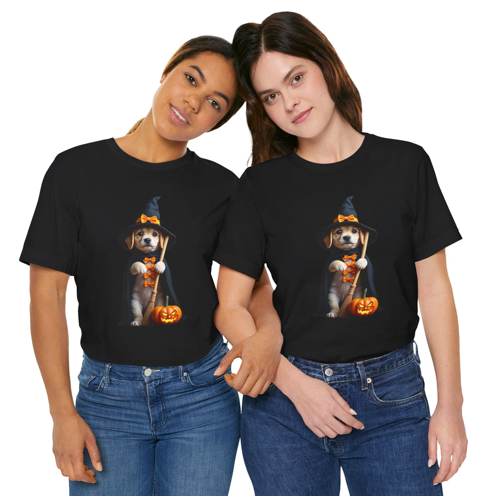 Two people wearing black t-shirts with a dog in a witch costume and pumpkin graphic.